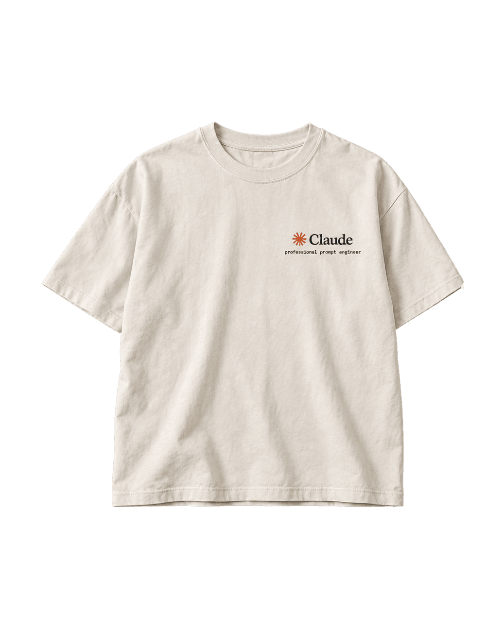 Cream Works On My Machine T-shirt, front view, with a small Claude chest logo and "professional prompt engineer".